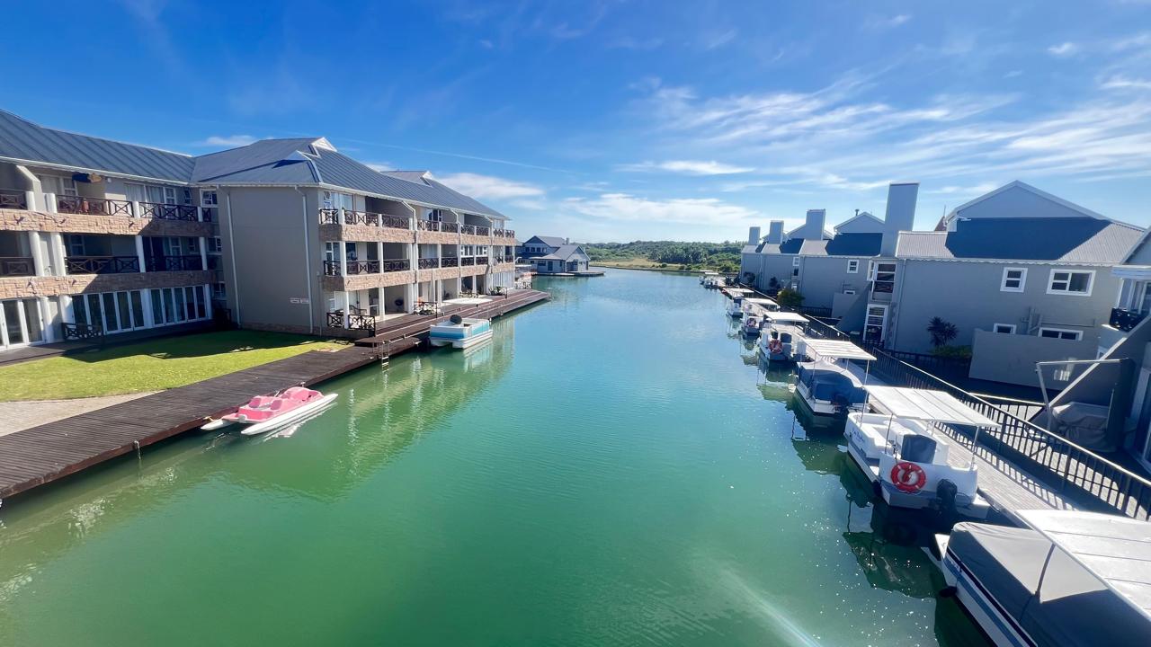 Sunlit water winding between the homes of Marina Martinique
